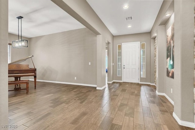 foyer entrance with recessed lighting, visible vents, baseboards, and wood finished floors