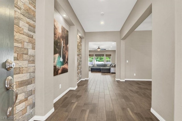 hall with dark wood-style floors and baseboards