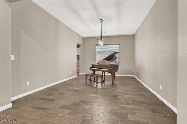 living area with wood finished floors and baseboards