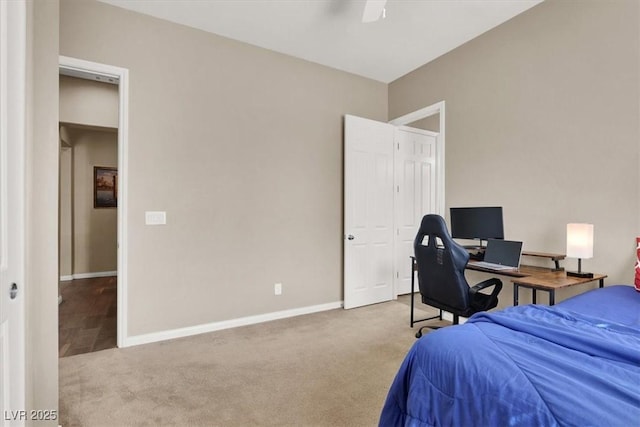 bedroom with a ceiling fan, carpet flooring, and baseboards