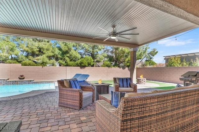 view of patio with ceiling fan, an outdoor living space with a fire pit, a fenced backyard, and a fenced in pool