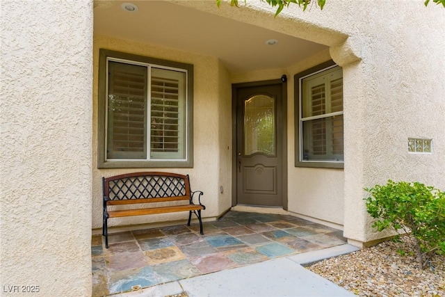 entrance to property with stucco siding