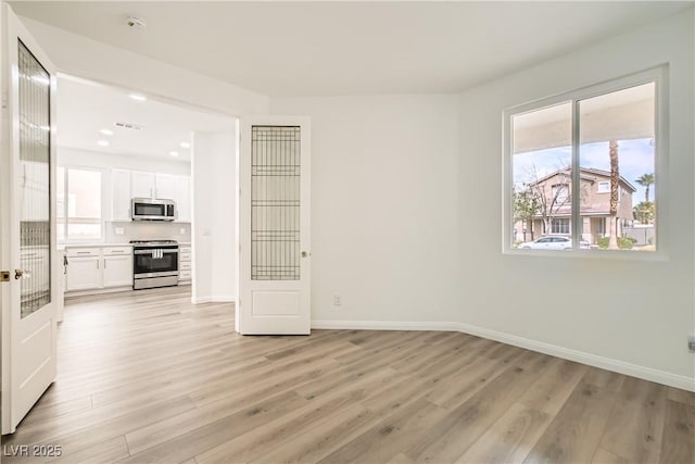 spare room with recessed lighting, baseboards, visible vents, and light wood finished floors