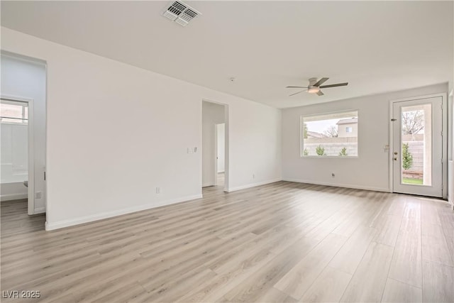 unfurnished room with visible vents, light wood-style flooring, baseboards, and a ceiling fan