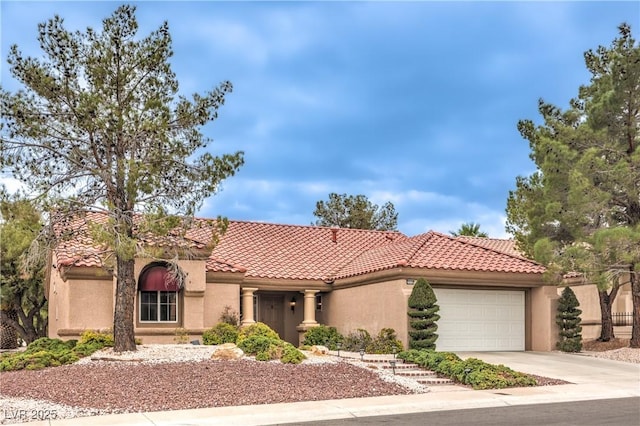 mediterranean / spanish-style house featuring a tile roof, driveway, an attached garage, and stucco siding