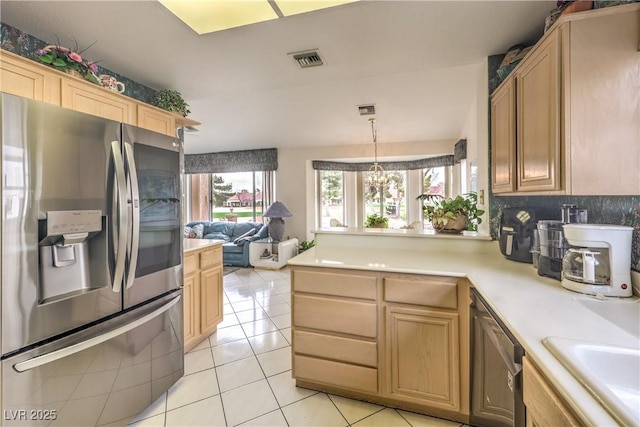 kitchen featuring light tile patterned flooring, stainless steel appliances, a peninsula, visible vents, and light countertops