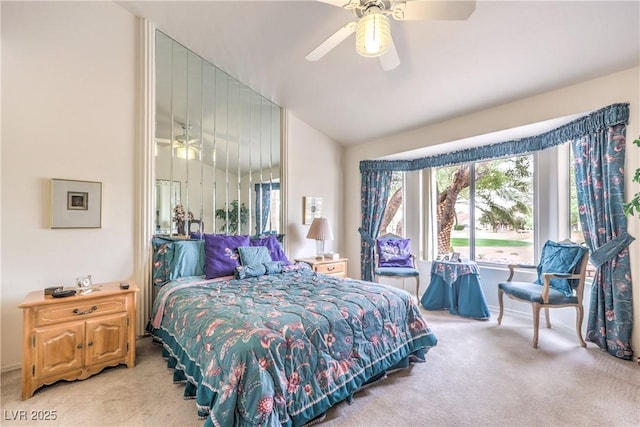 carpeted bedroom featuring ceiling fan and vaulted ceiling