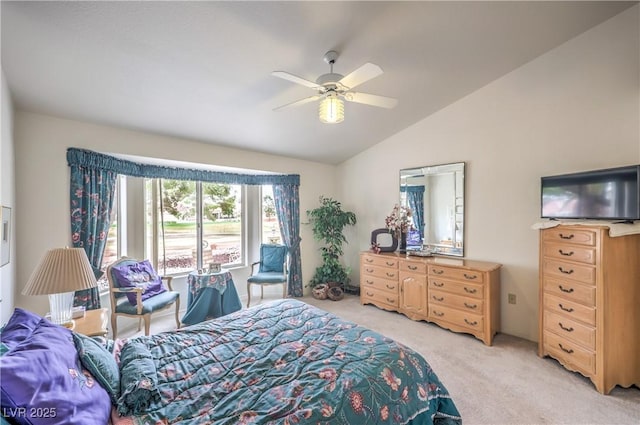 bedroom with ceiling fan, vaulted ceiling, and light colored carpet