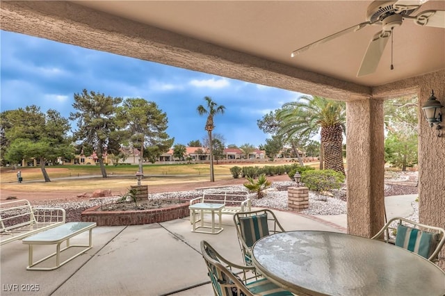 view of patio with outdoor dining area and ceiling fan