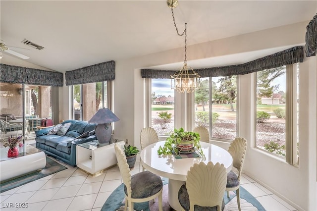 dining room featuring light tile patterned floors, vaulted ceiling, ceiling fan with notable chandelier, and visible vents