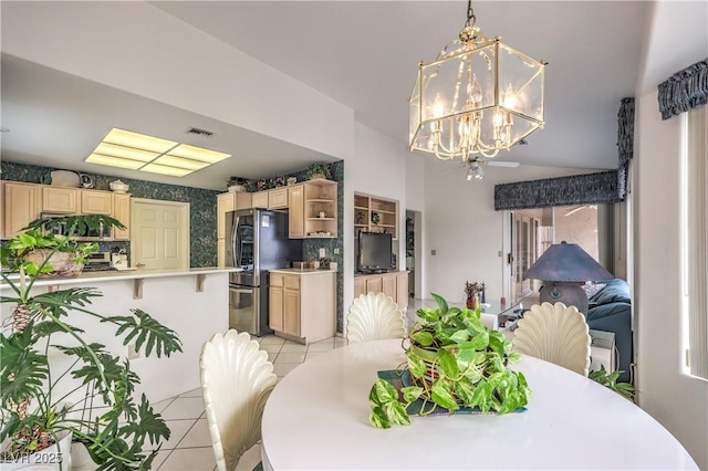 dining space with an inviting chandelier, light tile patterned floors, and visible vents