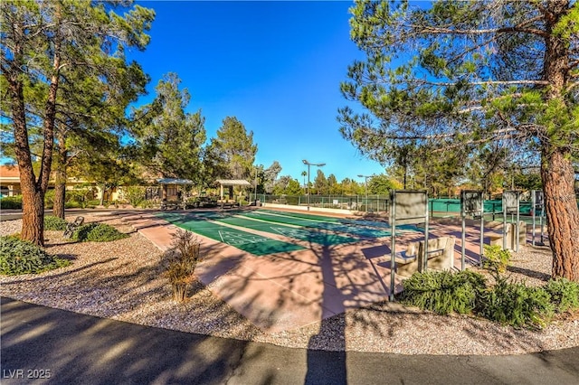 view of pool featuring shuffleboard and fence