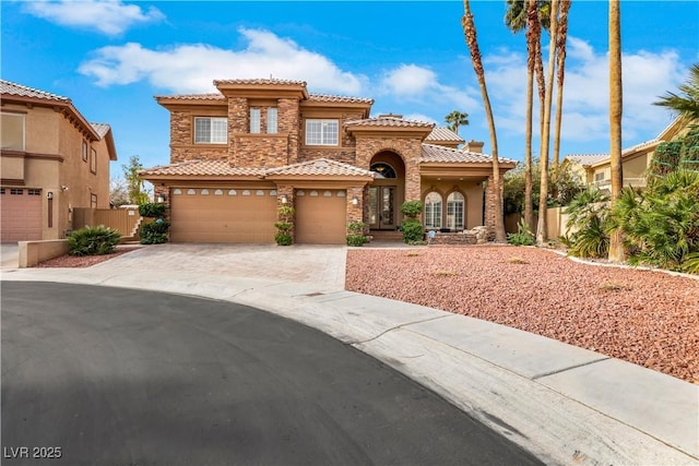 8925 Rio Verde Ave, Las Vegas, NV 89147 - mediterranean / spanish house featuring stone siding, a tile roof, fence, and driveway