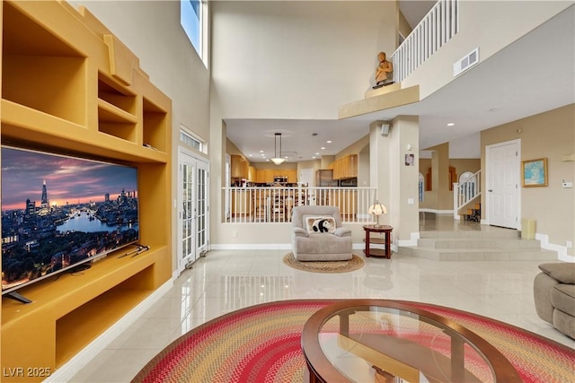 8925 Rio Verde Ave, Las Vegas, NV 89147 - living area featuring light tile patterned floors, a towering ceiling, visible vents, and baseboards