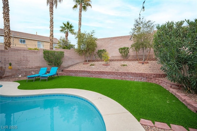 view of swimming pool with a fenced backyard, a fenced in pool, and a yard