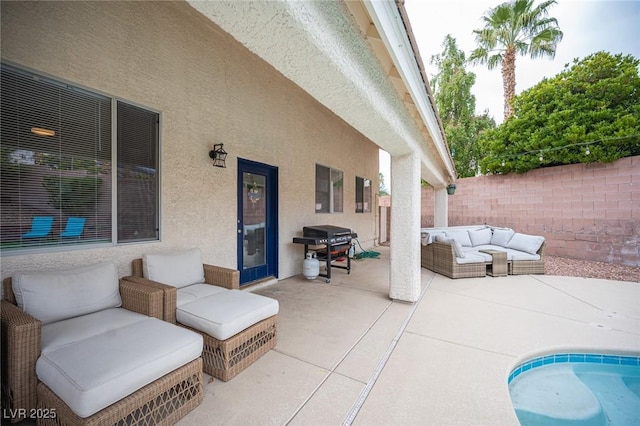 view of patio featuring area for grilling, a fenced backyard, and an outdoor living space