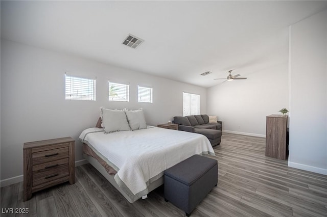 bedroom with visible vents, ceiling fan, baseboards, and wood finished floors