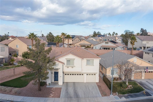 view of front of property with an attached garage, driveway, a residential view, and stucco siding