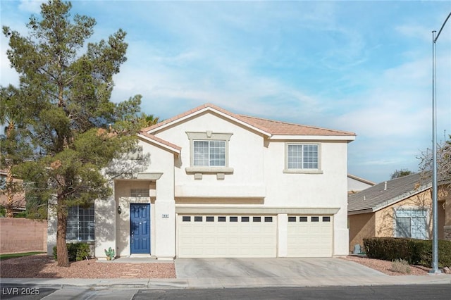 traditional home featuring a garage, concrete driveway, and stucco siding