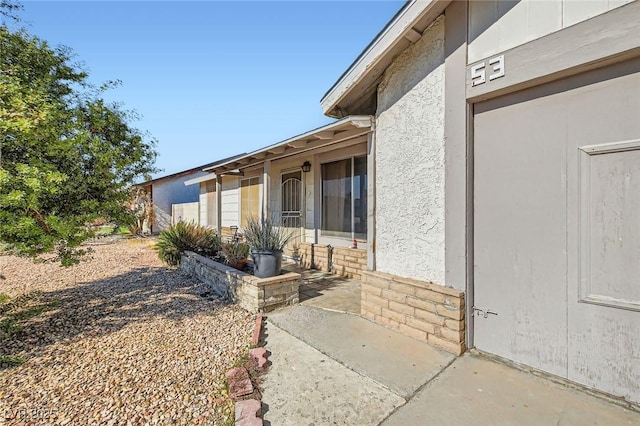 entrance to property with stucco siding