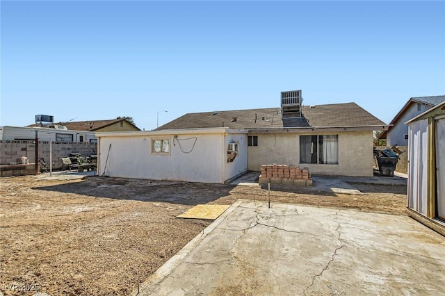 rear view of house featuring a patio and stucco siding