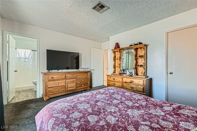 bedroom with ensuite bath, a textured ceiling, visible vents, and carpet flooring