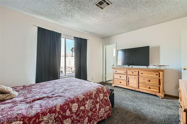 carpeted bedroom featuring visible vents and a textured ceiling