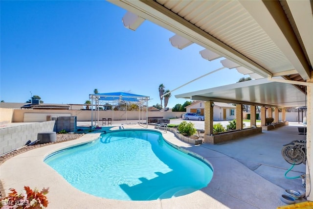 view of swimming pool with a patio area, fence, and a fenced in pool