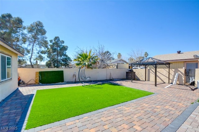 view of yard featuring a fenced backyard, a patio, and a gazebo