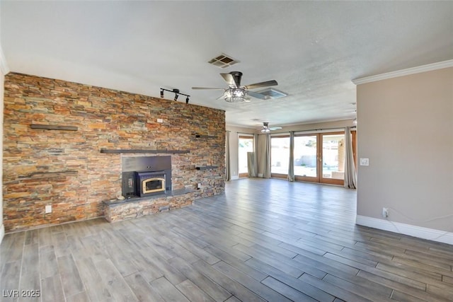 unfurnished living room with baseboards, visible vents, track lighting, and wood finished floors