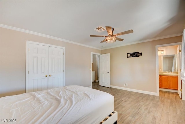 bedroom with baseboards, visible vents, ensuite bathroom, crown molding, and light wood-type flooring