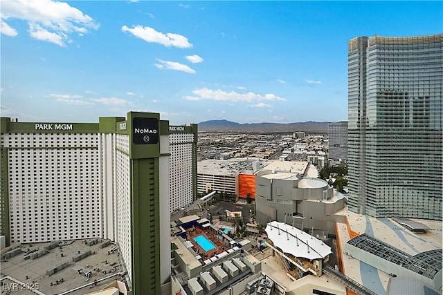 property's view of city featuring a mountain view