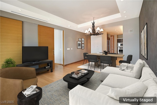 3750 Las Vegas Blvd Unit 2711, Las Vegas, NV 89158 - living room featuring a chandelier, recessed lighting, light wood finished floors, and a tray ceiling