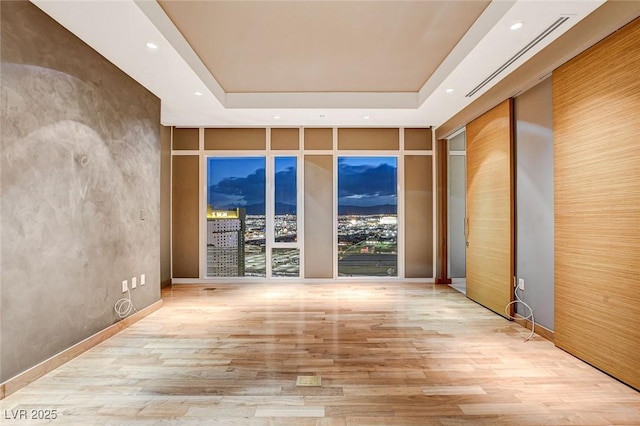 3750 Las Vegas Blvd Unit 2711, Las Vegas, NV 89158 - spare room featuring a tray ceiling, wood finished floors, and recessed lighting