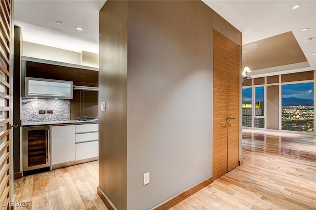 3750 Las Vegas Blvd Unit 2711, Las Vegas, NV 89158 - bar area with beverage cooler, light wood-type flooring, tasteful backsplash, stainless steel gas stovetop, and recessed lighting