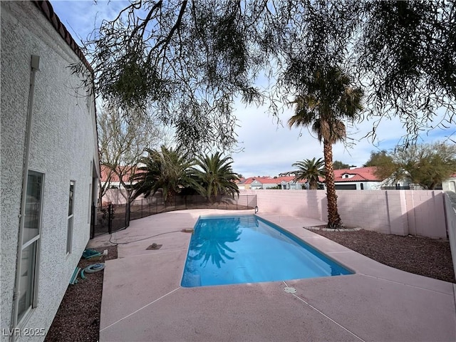 view of swimming pool with a fenced in pool, a patio, and a fenced backyard