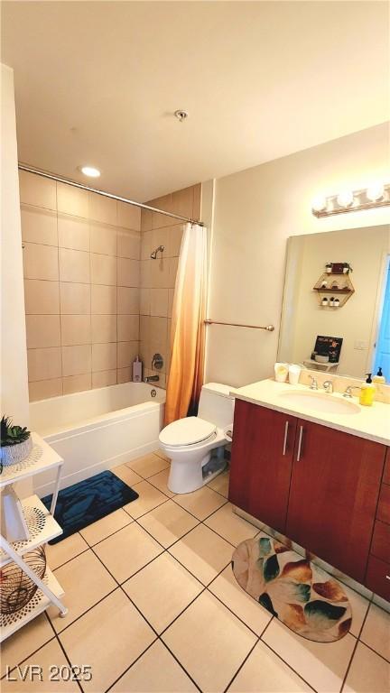 full bath featuring toilet, tile patterned flooring, shower / bathtub combination with curtain, and vanity