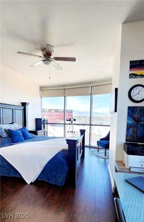 bedroom with dark wood finished floors, a ceiling fan, and floor to ceiling windows