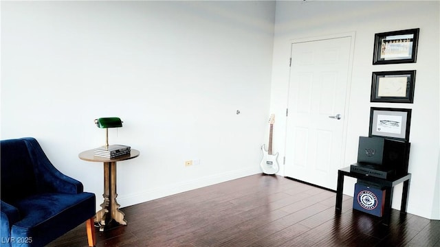 sitting room featuring dark wood finished floors and baseboards