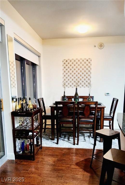 dining area with wood finished floors