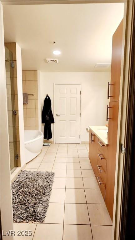 full bath with visible vents, tile patterned floors, a bathtub, vanity, and a shower stall