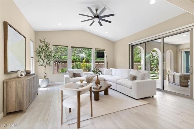 living room featuring baseboards, ceiling fan, vaulted ceiling, light wood-type flooring, and recessed lighting