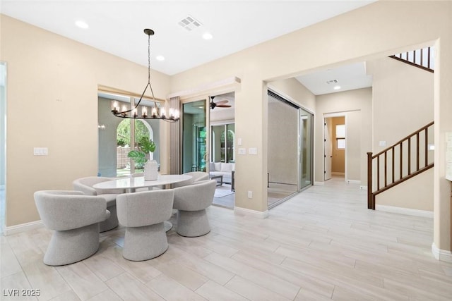 dining space with light wood finished floors, recessed lighting, stairway, baseboards, and ceiling fan with notable chandelier