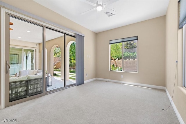 empty room featuring baseboards, carpet, visible vents, and a ceiling fan