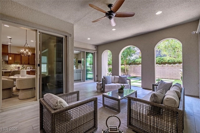 view of patio / terrace with ceiling fan, fence, and an outdoor hangout area