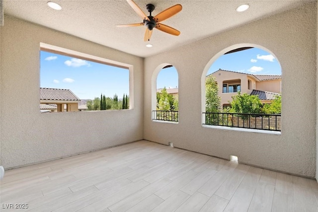 view of patio featuring ceiling fan and a balcony