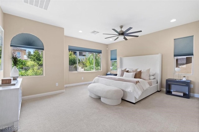 bedroom featuring light carpet, visible vents, and recessed lighting