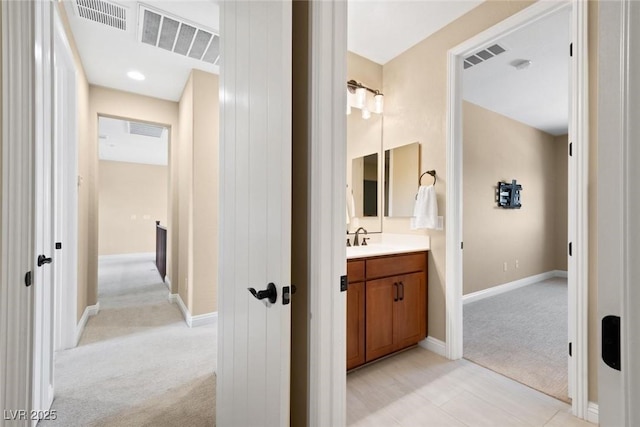 bathroom with visible vents, vanity, and baseboards