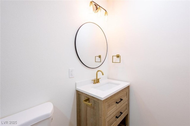 bathroom featuring toilet and vanity