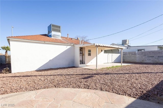 back of property featuring a patio area, central air condition unit, stucco siding, and fence